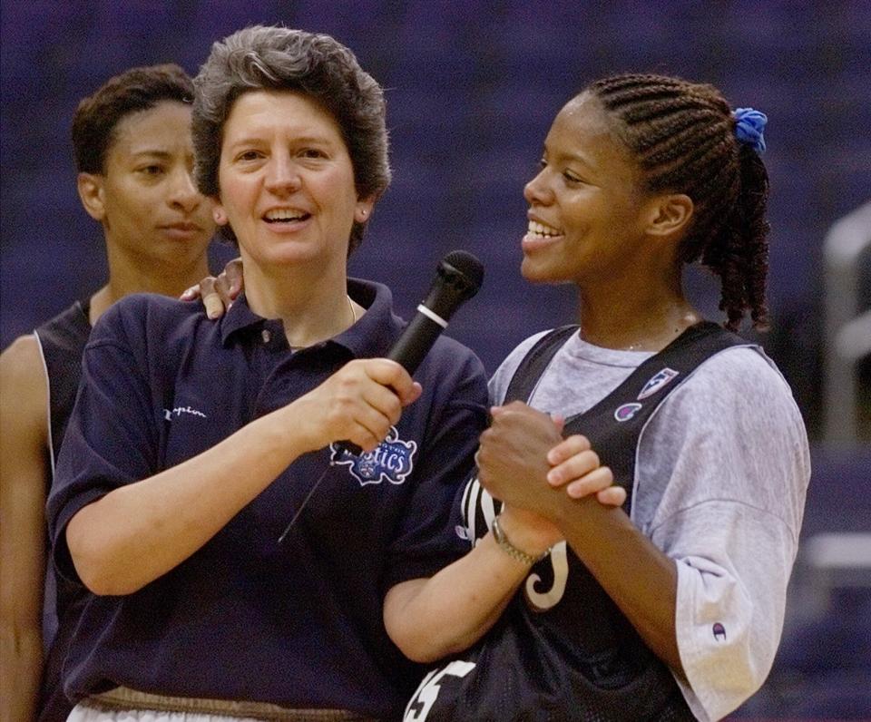FILE - In this Monday, June 7, 1999, file photo, Washington Mystics head coach Nancy Darsch, left, jokes with guard Nikki McCray as the coach introduces the players to fans who watched their practice session at the MCI center in Washington ahead of their season opener. Standing behind Darsch, is guard Penny Moore. Darsch, who guided the Ohio State women's basketball team to the 1993 title game and went on to coach in the WNBA, died Monday, Nov. 2, 2020, in her hometown of Plymouth, Massachusetts. She was 68.(AP Photo/Doug Mills, File)