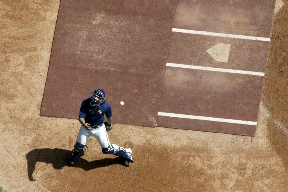 Milwaukee Brewers' Jacob Nottingham tries to catch a ball during a practice session Monday, July 13, 2020, at Miller Park in Milwaukee. (AP Photo/Morry Gash)