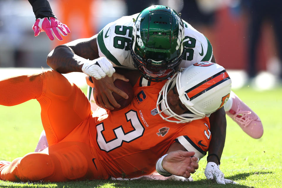 DENVER, COLORADO – OCTOBER 08: Quincy Williams #56 of the New York Jets hits <a class="link " href="https://sports.yahoo.com/nfl/players/25785" data-i13n="sec:content-canvas;subsec:anchor_text;elm:context_link" data-ylk="slk:Russell Wilson;sec:content-canvas;subsec:anchor_text;elm:context_link;itc:0">Russell Wilson</a> #3 of the <a class="link " href="https://sports.yahoo.com/nfl/teams/denver/" data-i13n="sec:content-canvas;subsec:anchor_text;elm:context_link" data-ylk="slk:Denver Broncos;sec:content-canvas;subsec:anchor_text;elm:context_link;itc:0">Denver Broncos</a> resulting in an unnecessary roughness penalty in the second quarter at Empower Field At Mile High on October 08, 2023 in Denver, Colorado. (Photo by Matthew Stockman/Getty Images)