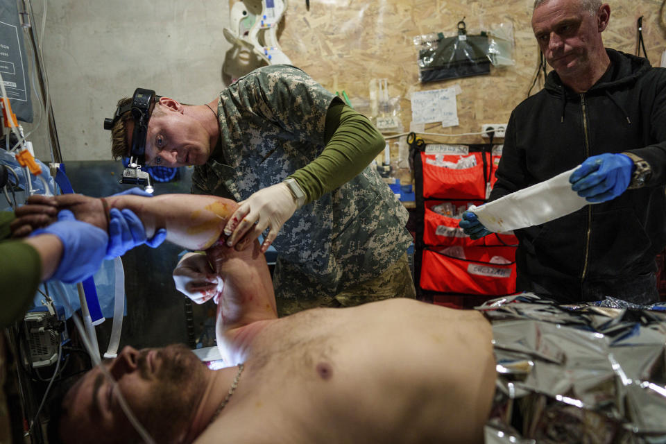 FILE – Viter, a doctor with Ukraine’s 47th Brigade, treats an injured comrade at the field hospital near Avdiivka, in the Donetsk region of Ukraine, on Friday, May 10, 2024. (AP Photo/Evgeniy Maloletka, File)