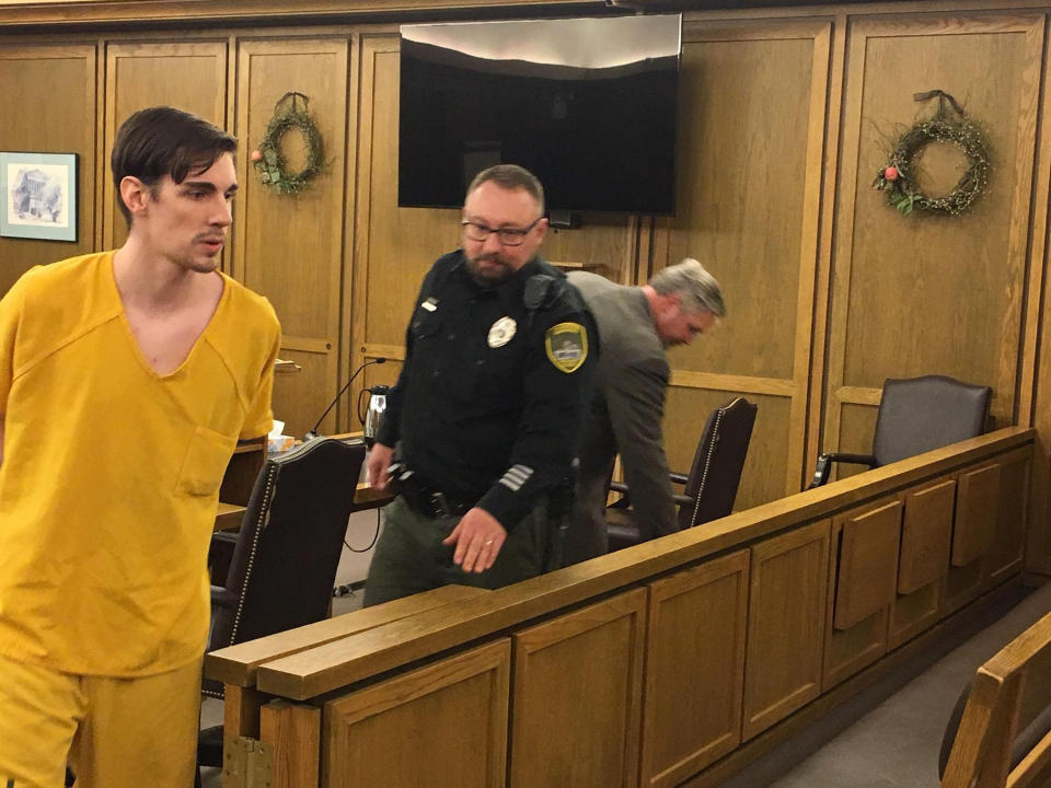 In this Friday, April 19, 2019, John A. Radavich, 24, left, is led back to jail after a hearing before Superior Court Judge Maryann Moreno in Spokane, Wash. The discovery of new evidence prompted a judge to declare a mistrial in the murder case against Radavich charged with killing the nephew of U.S. Sen. Jon Tester of Montana. The Spokesman-Review reports Friday, April 19, 2019, that court records show a sheriff's detective found a text message in the file while preparing to give testimony that hadn't been turned over to the defense. A new trial is set for August. (Thomas Clouse/The Spokesman-Review via AP, File)