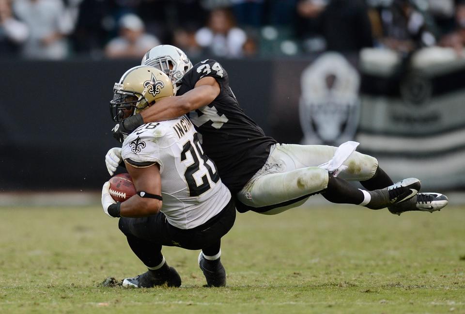 OAKLAND, CA - NOVEMBER 18: Mark Ingram #28 of the New Orleans Saints gets tackled around the kneck by Mike Mitchell #34 of the Oakland Raiders during the fouth quarter of an NFL football game at O.co Coliseum on November 18, 2012 in Oakland, California. The Saints won the game 38-17. (Photo by Thearon W. Henderson/Getty Images)