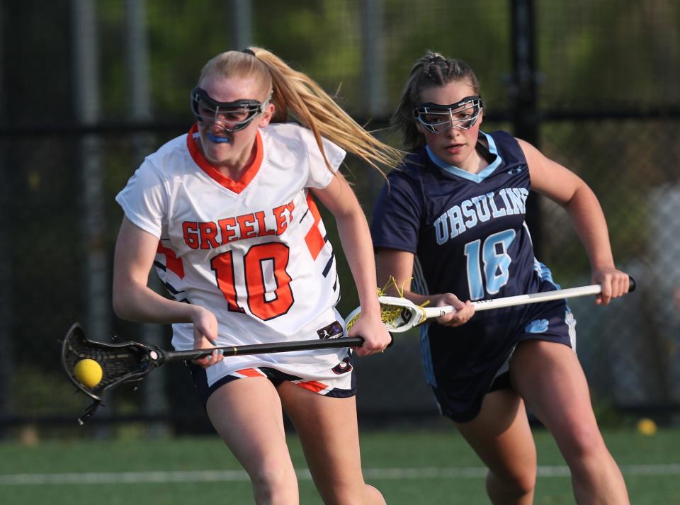Greeley's Erica Rosendorf (10) drives to the goal in front of Ursuline's Grace Egan (18) during girls lacrosse Class A semifinal at Horace Greeley High School in Chappaqua May 23, 2023. Greeley won the game 11-8.