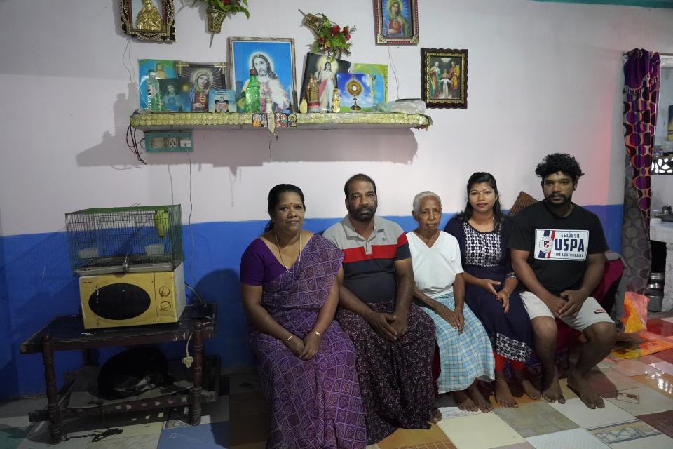 Mary Sebastian, center, poses for a photo with several family members in their home in the Chellanam area of Kochi, Kerala state, India, March 3, 2023. Sebastian, who lives in a fishing hamlet of 40,000 people in India's southern state of Kerala, fears many weather events exacerbated by climate change: cyclones, surging seas, flooding and erosion. (AP Photo)