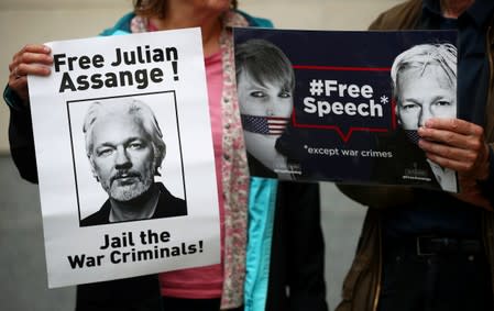 Demonstrators hold placards as they protest outside of Westminster Magistrates Court, where a case hearing for U.S. extradition of Wikileaks founder Julian Assange is held, in London