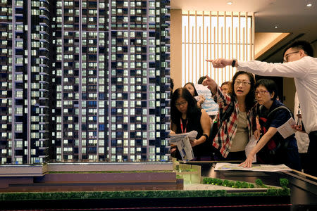 People look at a model of LP6 property development by Nan Fung Group at a sales centre in Hong Kong, China August 26, 2018. Picture taken August 26, 2018. REUTERS/Bobby Yip