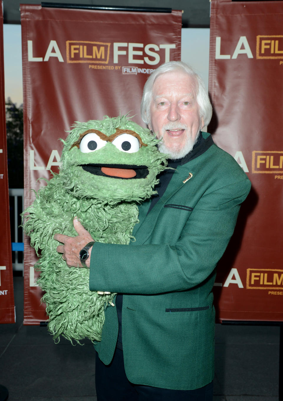 Spinney with Oscar the Grouch, another of his characters, at the 2014 premiere of the <em>I Am Big Bird </em>documentary, which told his story. (Photo: Getty Images)