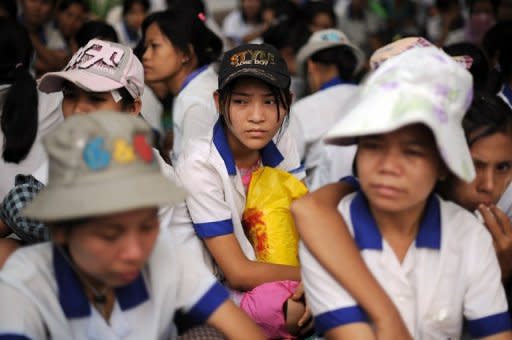 Myanmar labourers from a garment factory are seen sitting in protest outside their factory after staging a walkout, at the Hlaing Thar Yar industrial zone in Yangon, on May 16. Silenced for years under junta rule, Myanmar's workers are finding their voice to demand better pay -- with teething problems expected as staff and employers come to terms with unprecedented labour reform