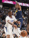 Los Angeles Clippers forward Norman Powell, left, passes the ball as Denver Nuggets forward Bruce Brown defends during the second half of an NBA basketball game Thursday, Jan. 5, 2023, in Denver. (AP Photo/David Zalubowski)