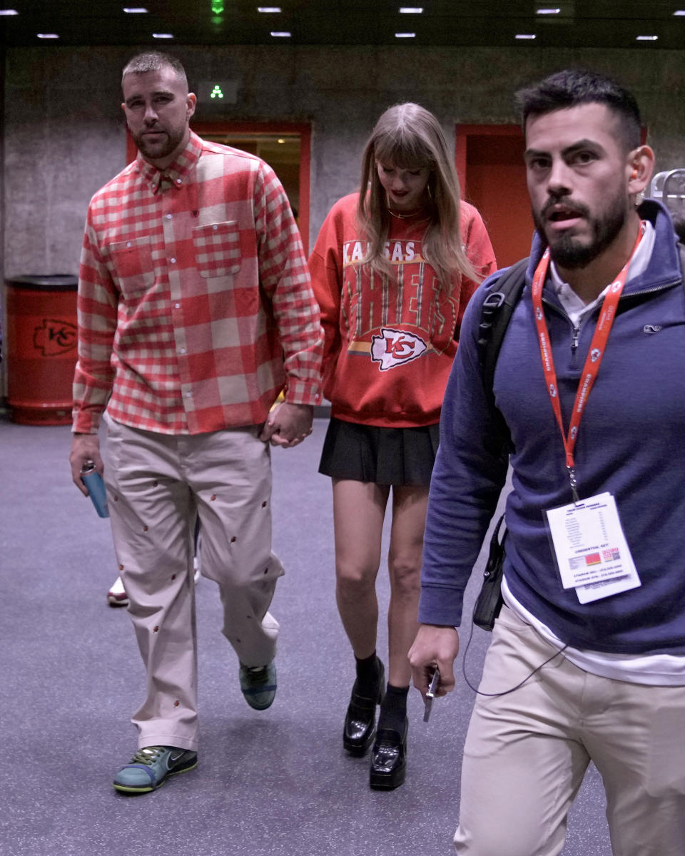 Kansas City Chiefs tight end Travis Kelce, left, and singer Taylor Swift leave Arrowhead stadium after an NFL football game between the Chiefs and the Los Angeles Chargers, Sunday, Oct. 22, 2023, in Kansas City, Mo. (AP Photo/Charlie Riedel)