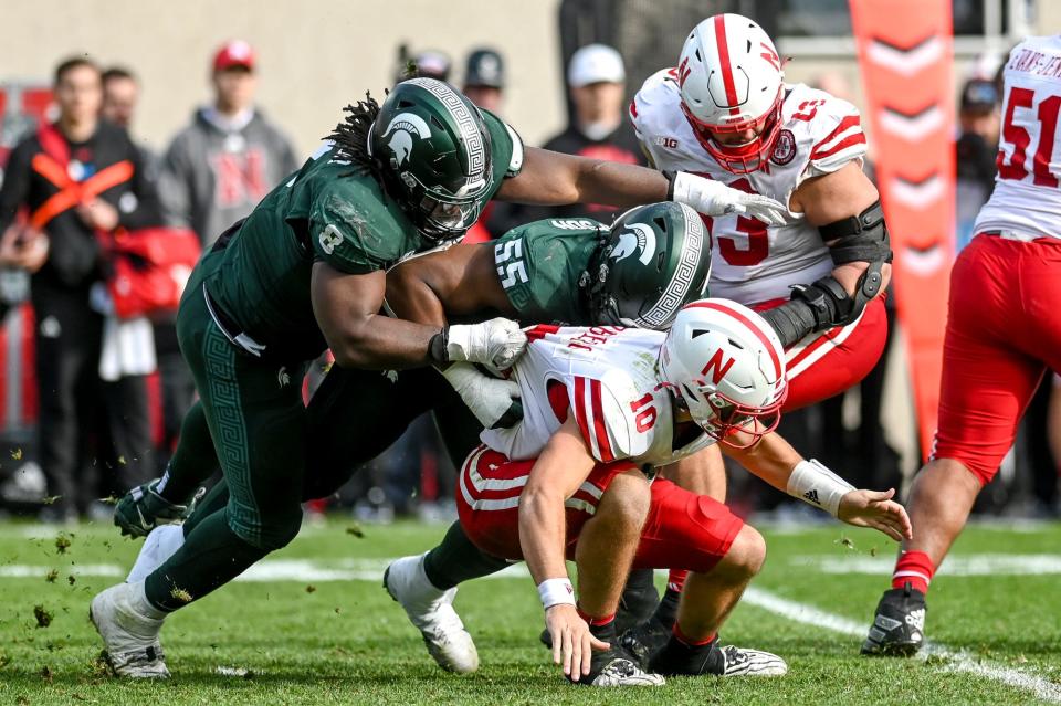 Michigan State's Simeon Barrow Jr., left, and Jalen Thompson force a fumble by Nebraska's Heinrich Haarberg during the fourth quarter on Saturday, Nov. 4, 2023, at Spartan Stadium in East Lansing.