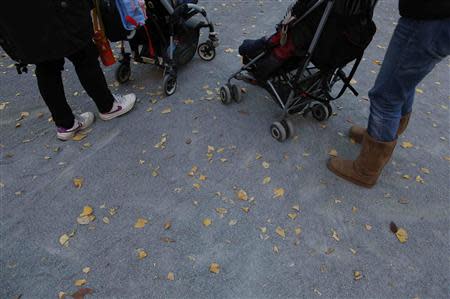 Filipino nannies stroll with children during their duty hours at a park in Tokyo November 29, 2013.REUTERS/Issei Kato