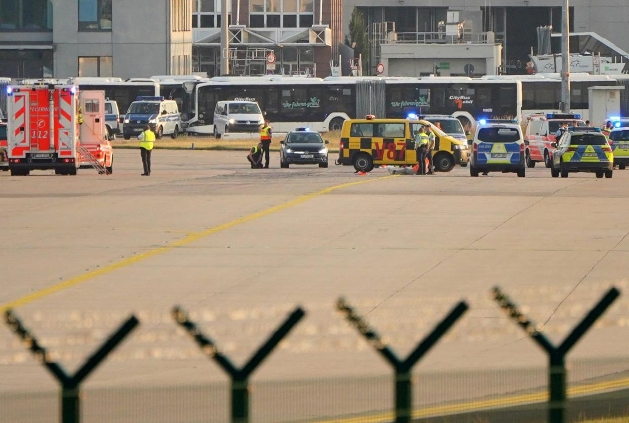 <span>Police, security and medical staff park their vehicles after Letzte Generation (Last Generation) activists staged a demonstration at Frankfurt airport.</span><span>Photograph: Timm Reichert/Reuters</span>