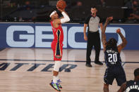 New Orleans Pelicans forward Josh Hart (3) shoots a three point basket over Orlando Magic guard Markelle Fultz (20) during the first half of an NBA basketball game Thursday, Aug. 13, 2020, in Lake Buena Vista, Fla. (Kim Klement/Pool Photo via AP)