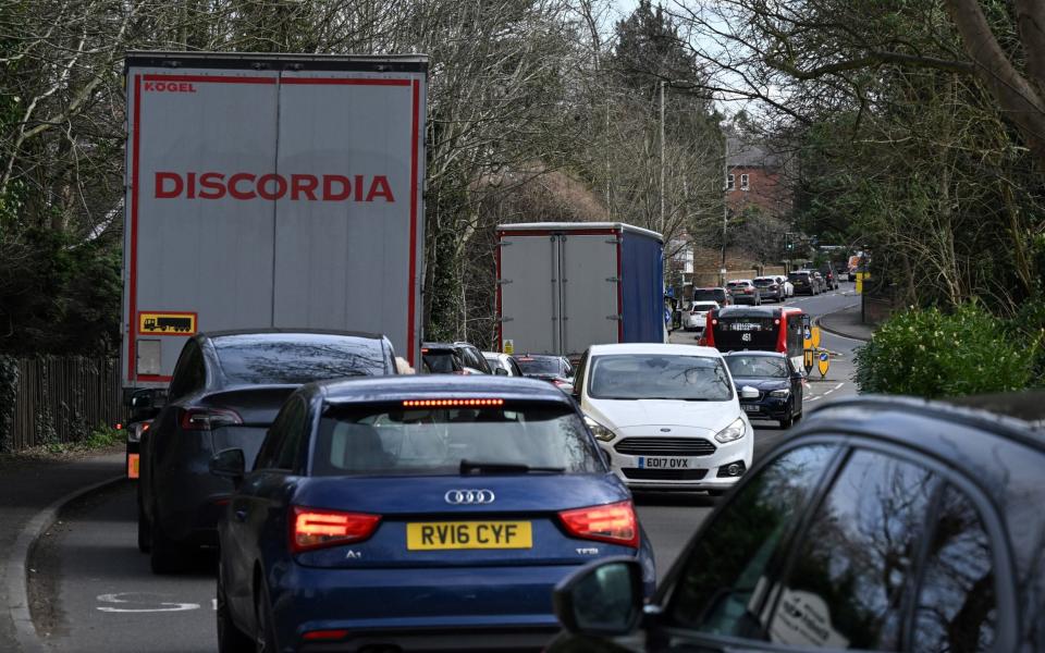 Vehicles queue along the street going into Weybridge