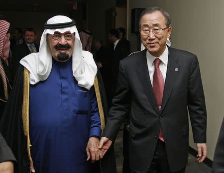 Saudi Arabia's King Abdullah bin Abdulaziz (L) hold hands with U.N. Secretary General Ban Ki-moon during a dinner prior to the start of the General Assembly Meeting of the Culture of Peace, at United Nations Headquarters, in New York in this November 11, 2008 file photo. REUTERS/UN Photo/Evan Schneider/Handout/Files