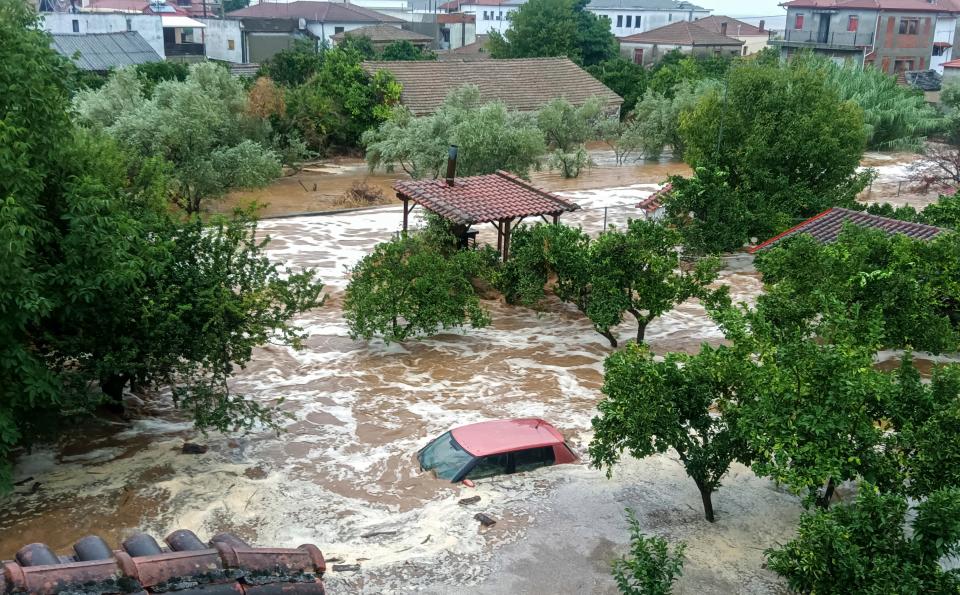 Floodwaters cover a car and the yards of houses in Milina village, Pilion region, central Greece, after a severe storm led to flooding, on Tuesday, Sept. 5, 2023.