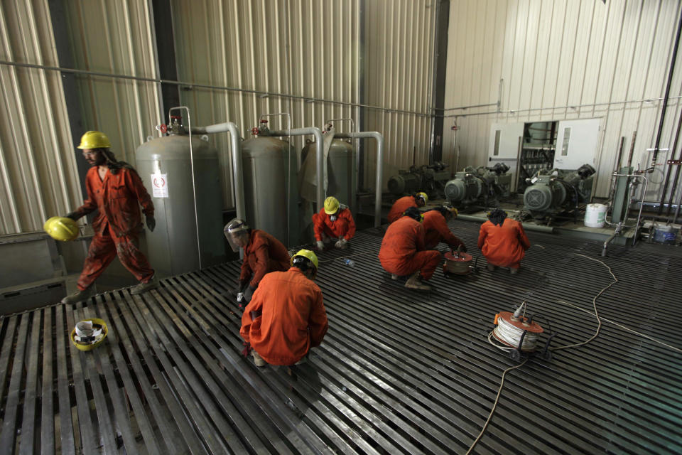 FILE - In this Friday, May 14, 2010 file photo, Afghan workers clean a section of the Tarakhil power plant on the outskirts of Kabul, Afghanistan. U.S. federal inspectors say that money is still flowing to Afghan ministries from the U.S. Agency for International Development despite assessments that they can't manage or account for the funding. The Special Inspector General for Afghanistan, which oversees Afghan reconstruction, said in a report published Tuesday, Jan. 30, 2014 that external auditing in recent years showed the ministries were unable to account for or manage the funding.(AP Photo/Saurabh Das, File)