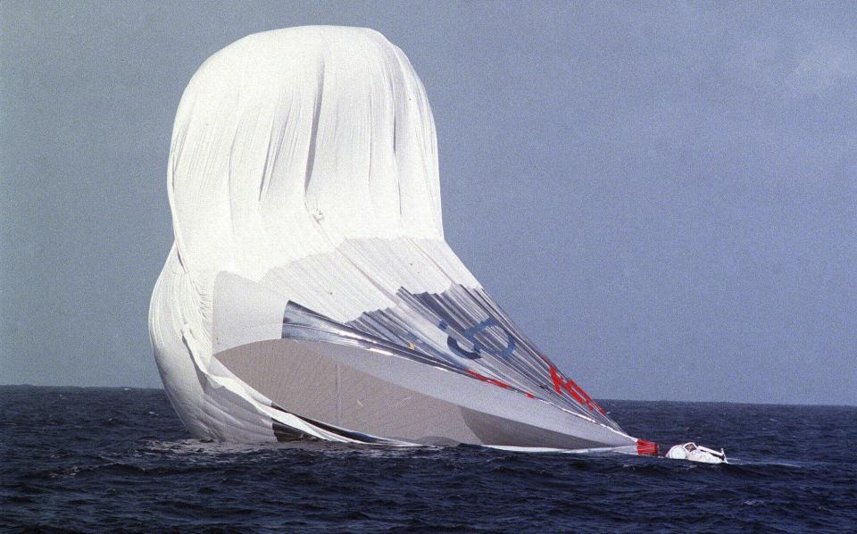 FILE - A huge tear forms in the fabric of The Global Challenger as it rests in waters 10-15 miles North of the island of Oahu in the Hawaiian Islands, Dec. 25, 1998. Steve Fossett, along with Per Lindstrand of Sweden and British mogul Richard Branson, who were attempting to make the first nonstop round-the-world flight in a balloon, were rescued after abandoning their quest. The massive hunt for the Titan submersible that imploded deep in the North Atlantic has refocused attention on whether wealthy risktakers should pay for emergency search and rescue efforts. (Richard Ambo/Honolulu Star-Advertiser via AP, File)