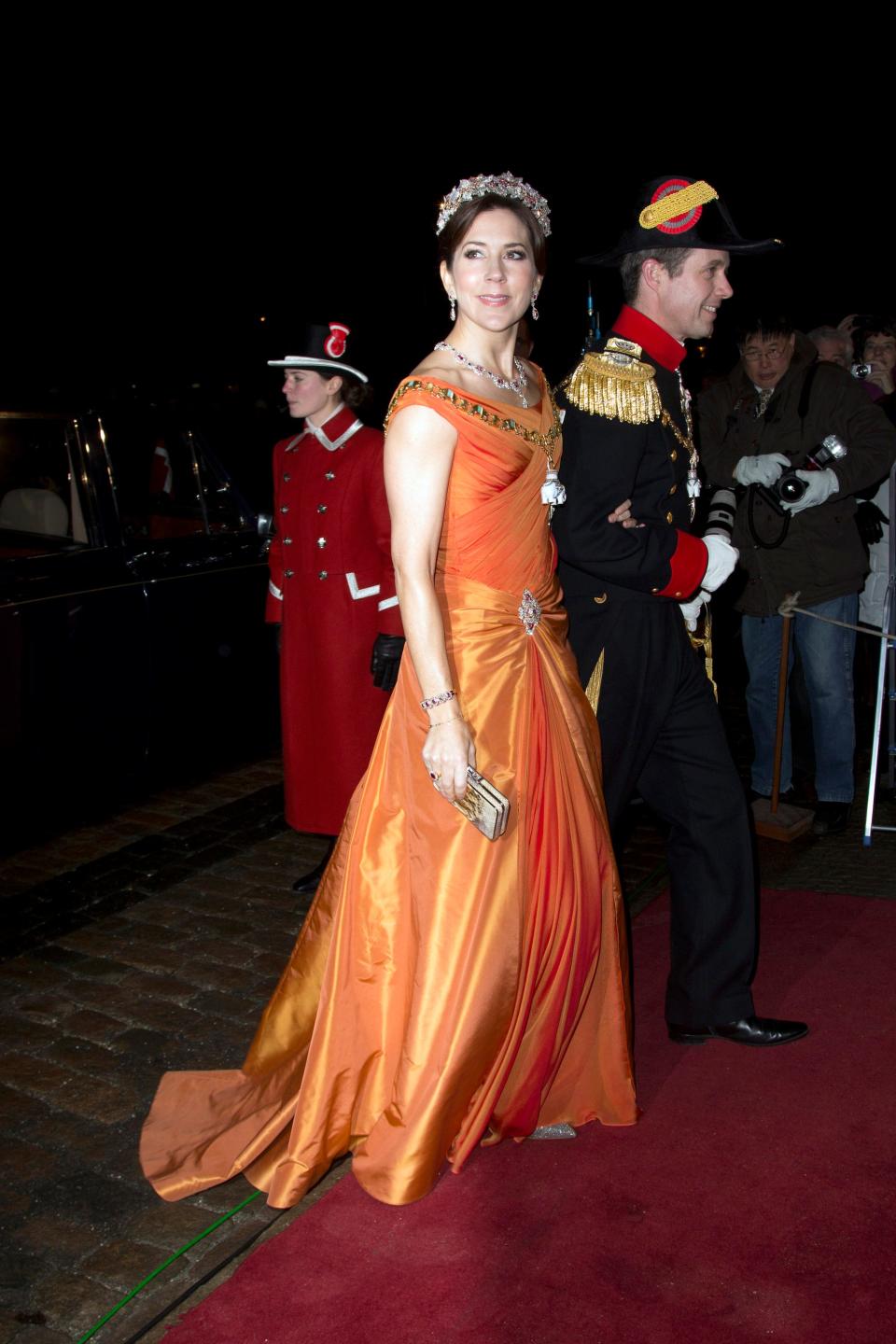 Crown Princess Mary wearing orange gown and tiara