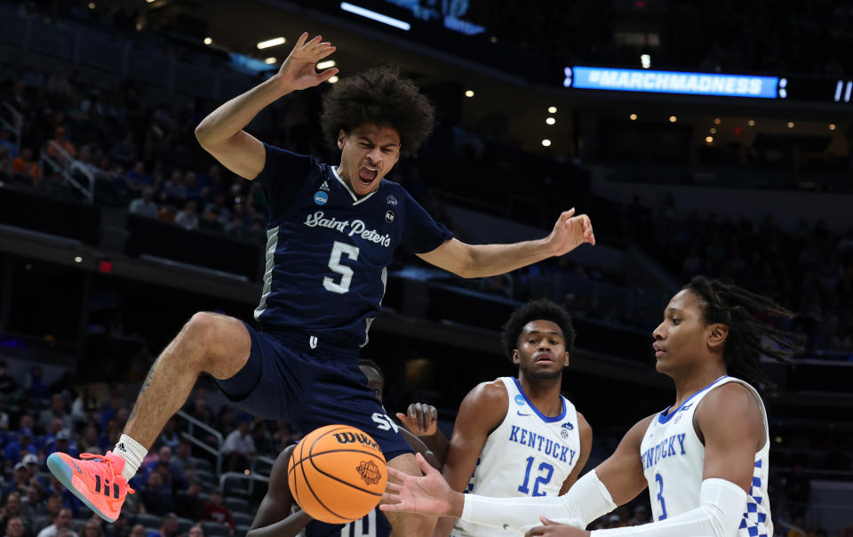 Mar 17, 2022; Indianapolis, IN, USA; Saint Peter's Peacocks guard Daryl Banks III (5) dunks the ball against the Kentucky Wildcats during the first round of the 2022 NCAA Tournament at Gainbridge Fieldhouse. Mandatory Credit: Trevor Ruszkowski-USA TODAY Sports