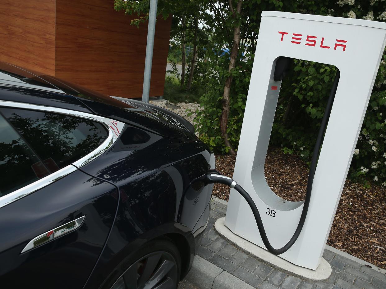 Image showing a Tesla being charged at a Tesla charging station.