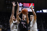 Omaha's Dylan Brougham (14) shoots between Purdue's Caleb Furst (3) and Zach Edey during the first half of an NCAA college basketball game in West Lafayette, Ind., Friday, Nov. 26, 2021. (AP Photo/Michael Conroy)