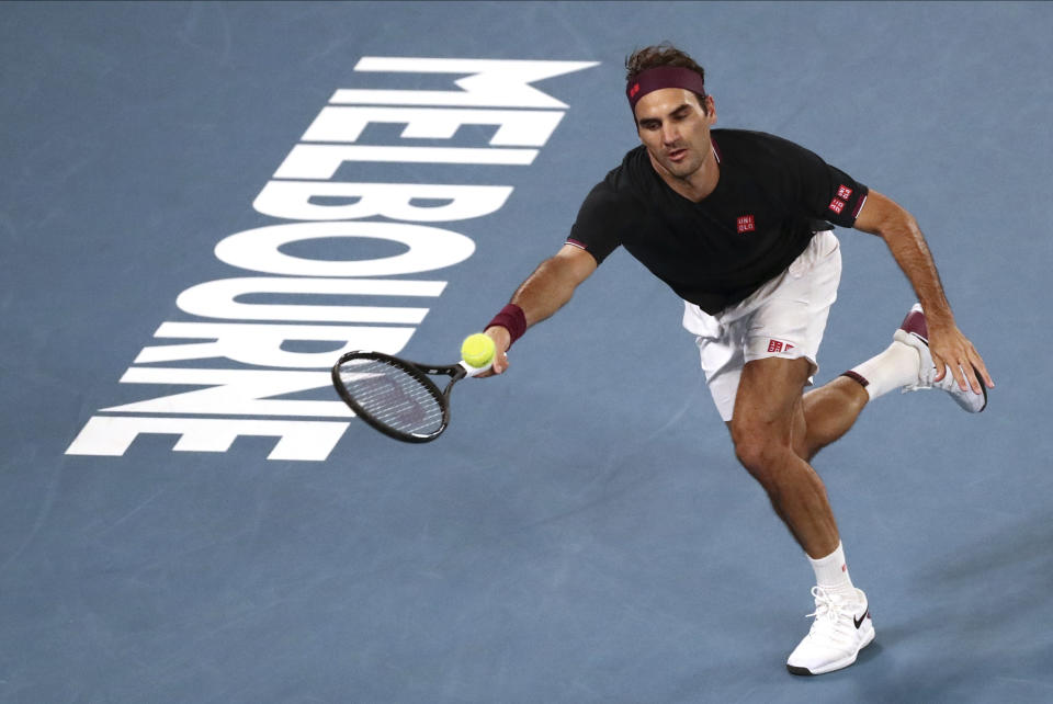 Switzerland's Roger Federer makes a forehand return to Australia's John Millman during their third round singles match at the Australian Open tennis championship in Melbourne, Australia, Friday, Jan. 24, 2020. (AP Photo/Dita Alangkara)