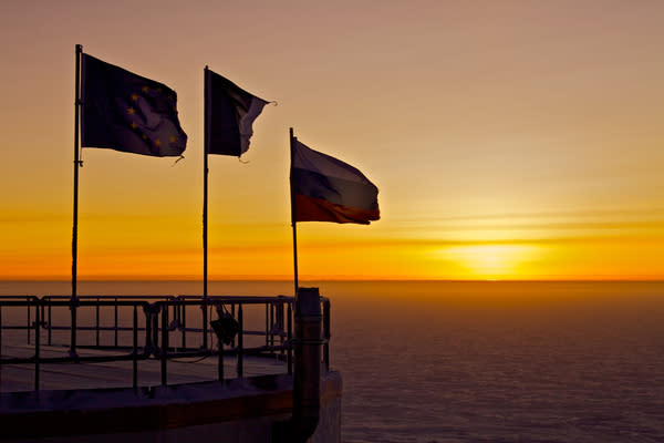 On Aug. 12, the first sunrise at Concordia Research Station reveals flags tattered by the brutal conditions of Antarctica's dark winter months.