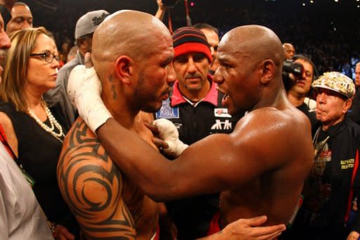 Floyd Mayweather (R) hugs Miguel Cotto after defeating him by unanimous decision in their WBA super welterweight title fight at the MGM Grand Garden Arena, on May 5, in Las Vegas, Nevada