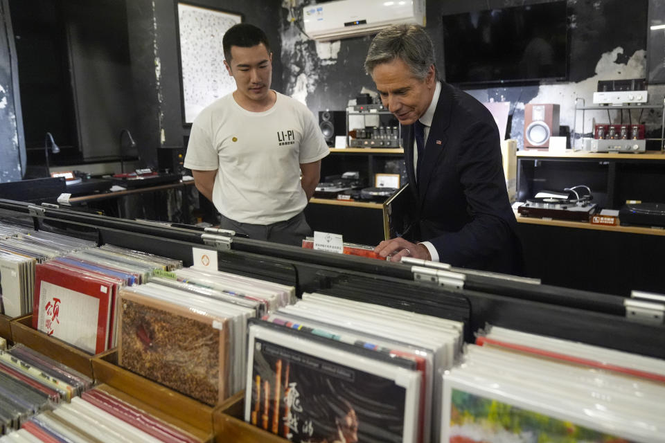 U.S. Secretary of State Antony Blinken talks with Yuxuan Zhou during a visit to Li-Pi record record store in Beijing, China, Friday, April 26, 2024. (AP Photo/Mark Schiefelbein, Pool)