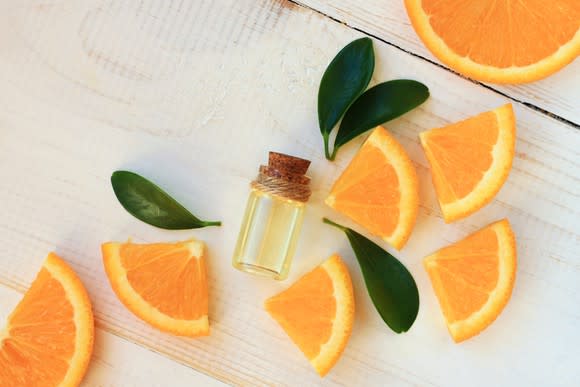 Orange slices and a small vial of citrus oil.