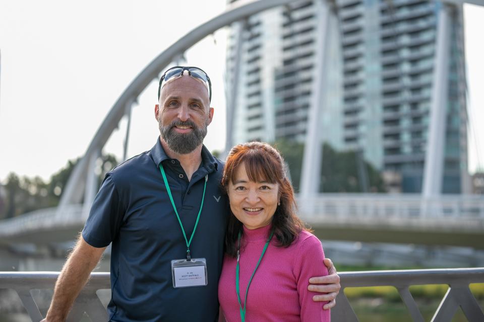 Scott Whitefield and Kyo Nakahama, descendants of Captain William Whitfield and Manjiro, pose in front of the Main Street Bridge in Columbus.