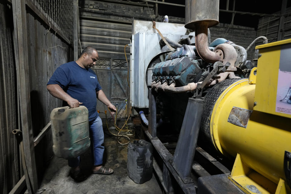 Saad Haider fuels a generator to provide electricity to private homes in Baghdad, Iraq, Tuesday, July 12, 2022. Private generators are ubiquitous in parts of the Middle East, spewing hazardous fumes into homes and business across the country, almost 24 hours a day. As the world looks for renewable energy to tackle climate change, Lebanon, Iraq, Gaza and elsewhere rely on diesel-powered private generators just to keep the lights on. The reason is state failure: In multiple countries, governments can’t maintain a functioning central power network, whether because of war, conflict or mismanagement and corruption. (AP Photo/Hadi Mizban)