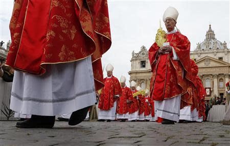 Cardinals arrive in a procession as Pope Francis leads the Palm Sunday mass at Saint Peter's Square at the Vatican April 13, 2014. REUTERS/Alessandro Bianchi