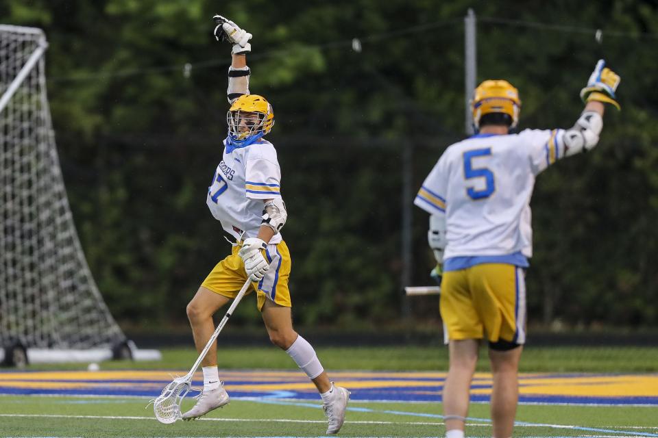 Mariemont midfielder Connor Souders (27) reacts after scoring a goal with attacker Boden Gall (5) in the first half against Cincinnati Hills Christian Academy at Mariemont High School May 26, 2022.