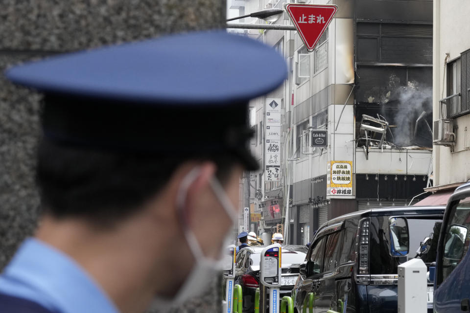 A police officer stands guard near the scene of an explosion in a building Monday, July 3, 2023, in Tokyo. (AP Photo/Eugene Hoshiko)