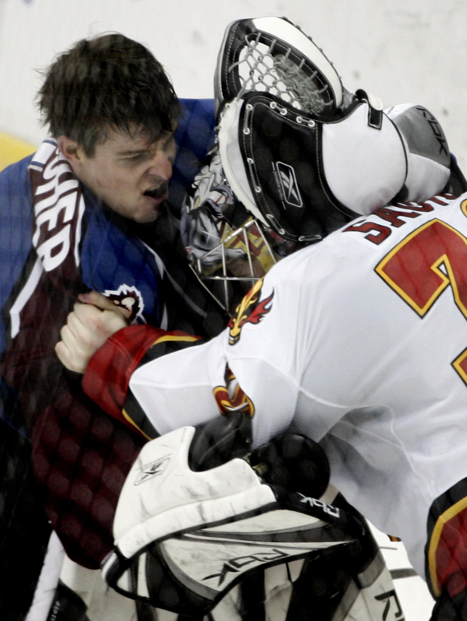 FILE - Colorado Avalanche goaltender David Aebischer, left, from Switzerland, and Calgary Flames goaltender Phillipe Sauve, right, fight in the third period of an NHL hockey game Jan. 24, 2006, in Denver. The league rule changes have made it so punitive that goalie fighting has essentially disappeared from the highest level of hockey. (AP Photo/Jack Dempsey, File)