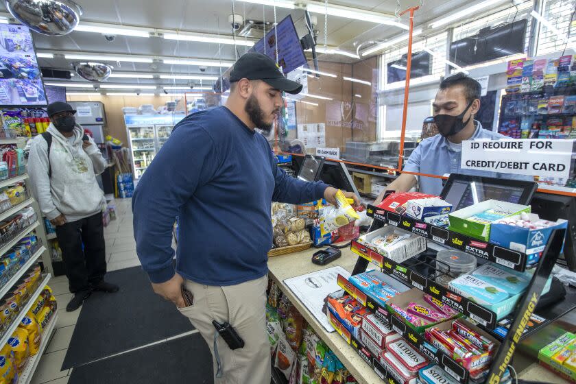 LOS ANGELES, CA-JULY 28, 2022: Enrique Garcia of Los Angeles shops inside Trimana Fresh Food Market on Broadway in downtown Los Angeles. Los Angeles County health officials announced today that they will not impose a mandatory indoor mask mandate in response to elevated COVID-19 transmissions and hospitalizations. (Mel Melcon/Los Angeles Times)