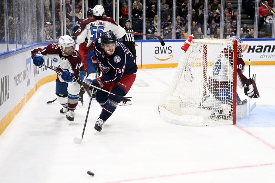 Andrew Cogliano, left,of Colorado Avalanche vies with Cole Sillinger of Columbus Blue Jackets, during the 2022 NHL Global Series ice hockey match between Colorado Avalanche and Columbus Blue Jackets in Tampere, Finland, Saturday, Nov. 5, 2022. (Emmi Korhonen./Lehtikuva via AP)