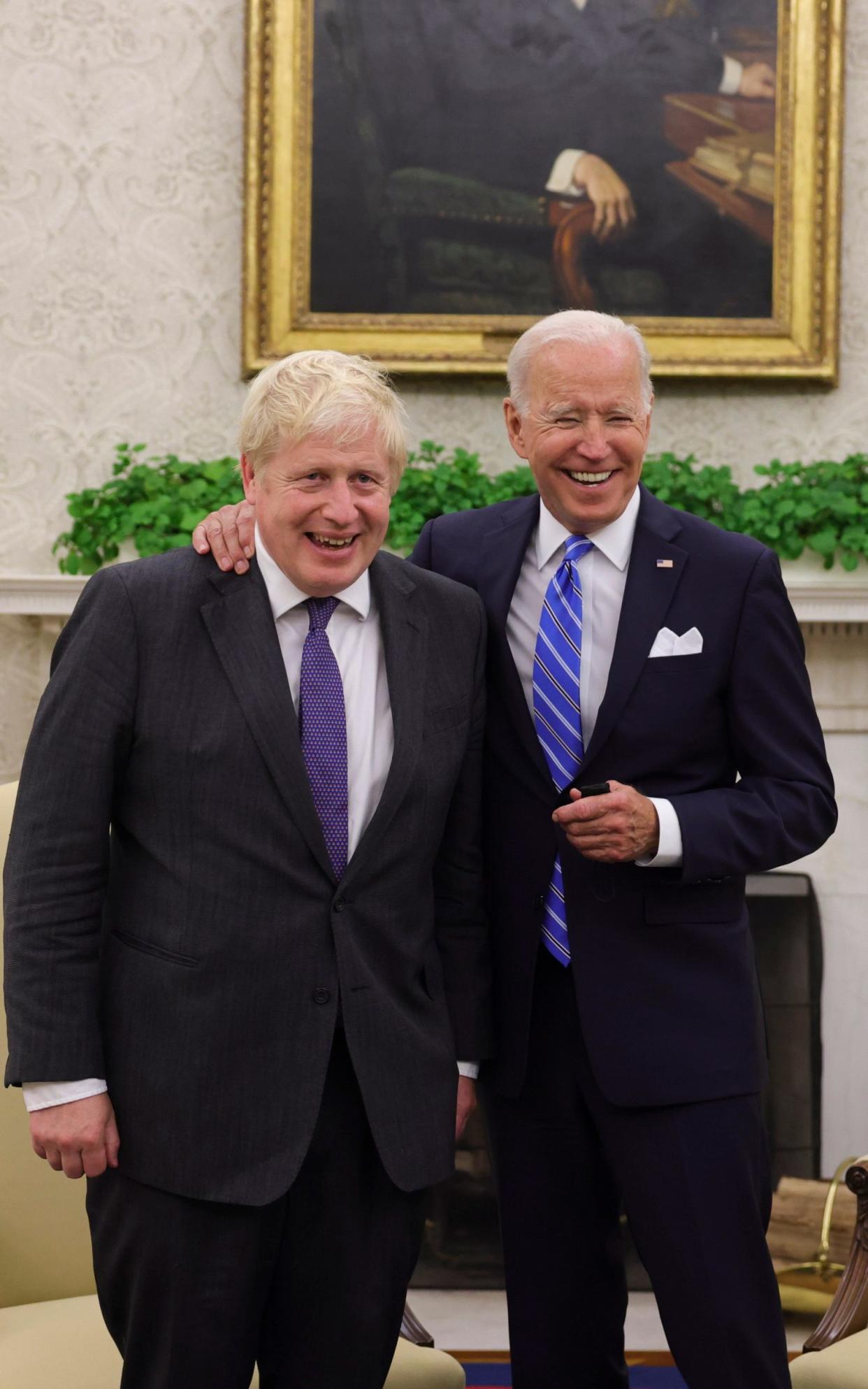 Prime Minister Boris Johnson holds a bilateral meeting with the Presidents of the United States of America in the Oval Office in the White House, Washington DC. The world leaders smile for a photo as Joe Biden puts his arm around Boris Johnson. - Andrew Parsons / No10 Downing Street/No10 Downing Street