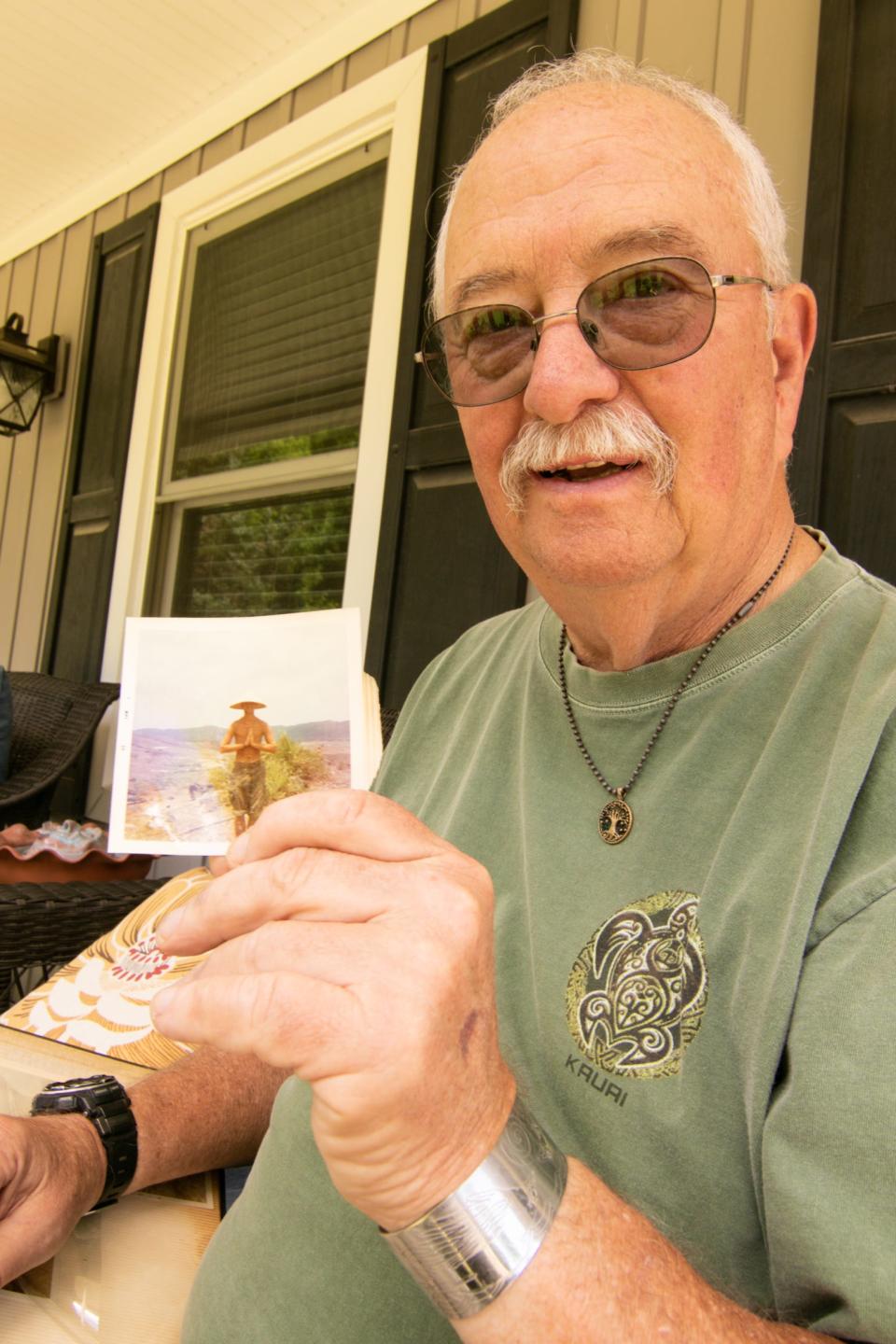 Hartland Township resident Ron Brooks holds a photo of himself Monday, June 27, 2022, while he was serving in Khe Sanh as a Marine during the Vietnam War.