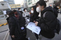 Students arrive to take the college entrance exam at a high school in Seoul, South Korea, Thursday, Dec. 3, 2020. South Korean officials urged on Wednesday people to remain at home if possible and cancel gatherings as about half a million students prepare for the crucial national college exam. (AP Photo/Ahn Young-joon)