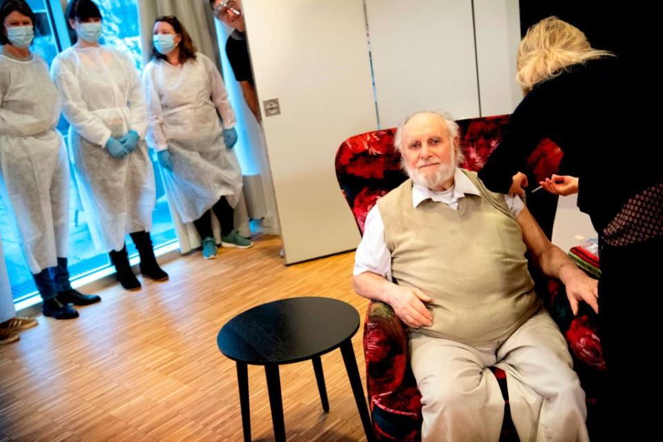 Nursing home resident Carl-Einar Joergensen receives a second injection of the vaccine from Pfizer/BioNTech by doctor Puk Laugen at the Plejecenter Faelledgaarden in Osterbro in Copenhagen, Denmark.