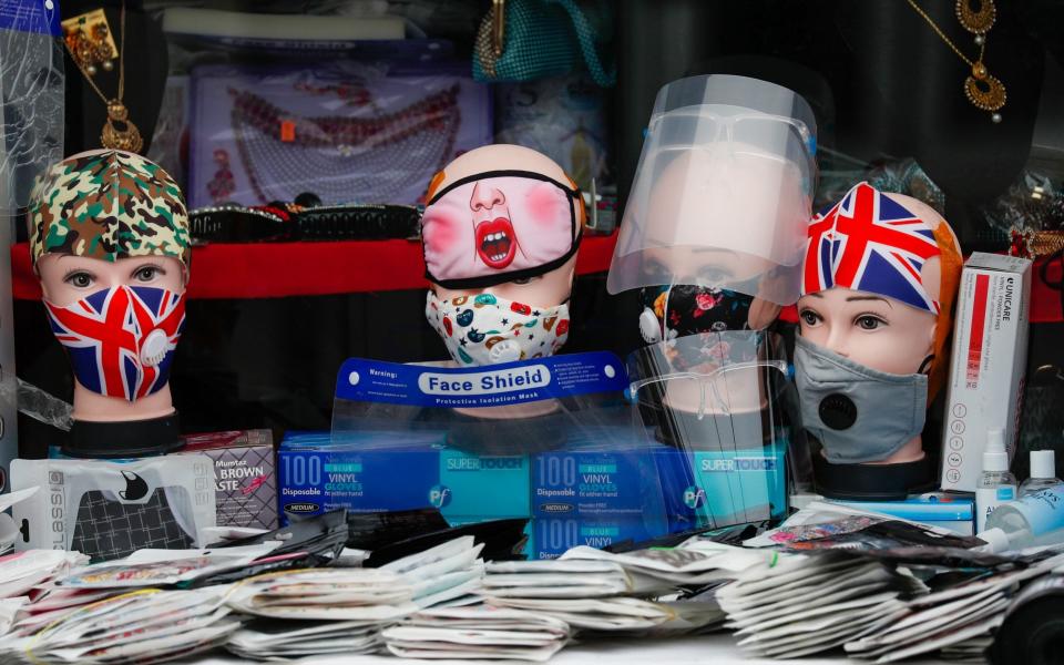 Face coverings sit on display outside a shop during the coronavirus pandemic in West Bromwich