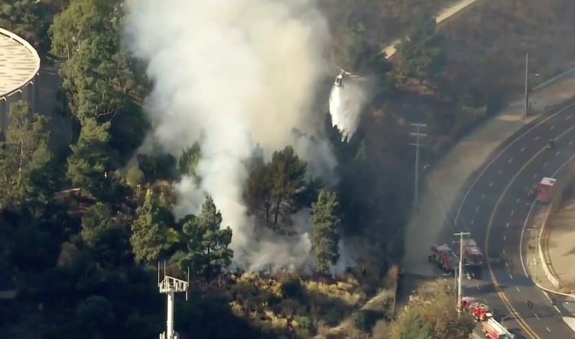 Fire fighters battle a brush fire in the Sepuveda Pass.