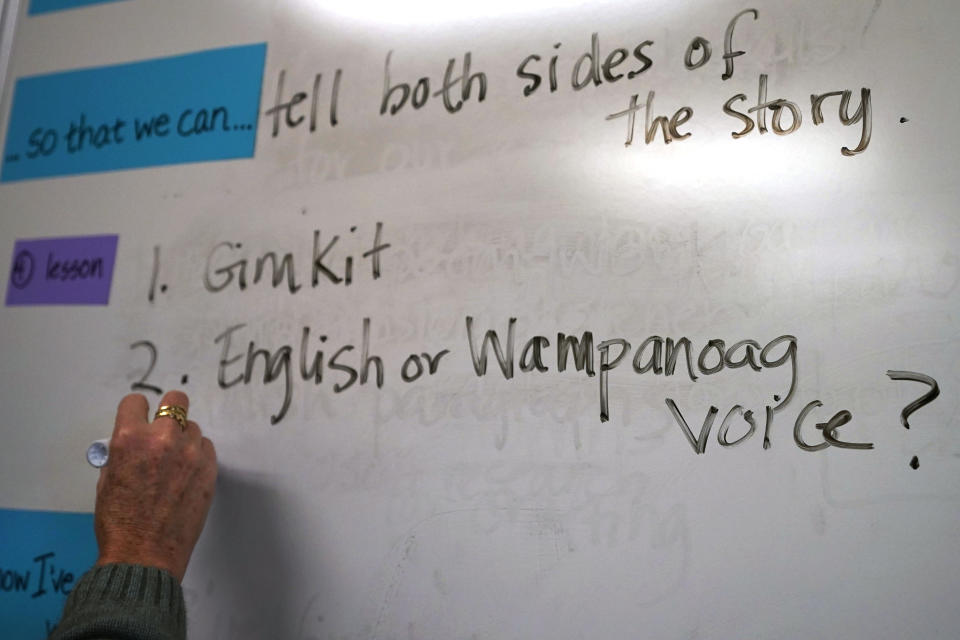 Susannah Remillard writes on the board for her sixth-grade class at Cape Cod Lighthouse Charter School, Thursday, Nov. 19, 2020, in East Harwich, Mass. In a growing number of U.S. schools, students are now learning a more complex Thanksgiving story that involves conflict, injustice and a new focus on the native people who lived in New England for hundreds of years before European settlers arrived. (AP Photo/Elise Amendola)