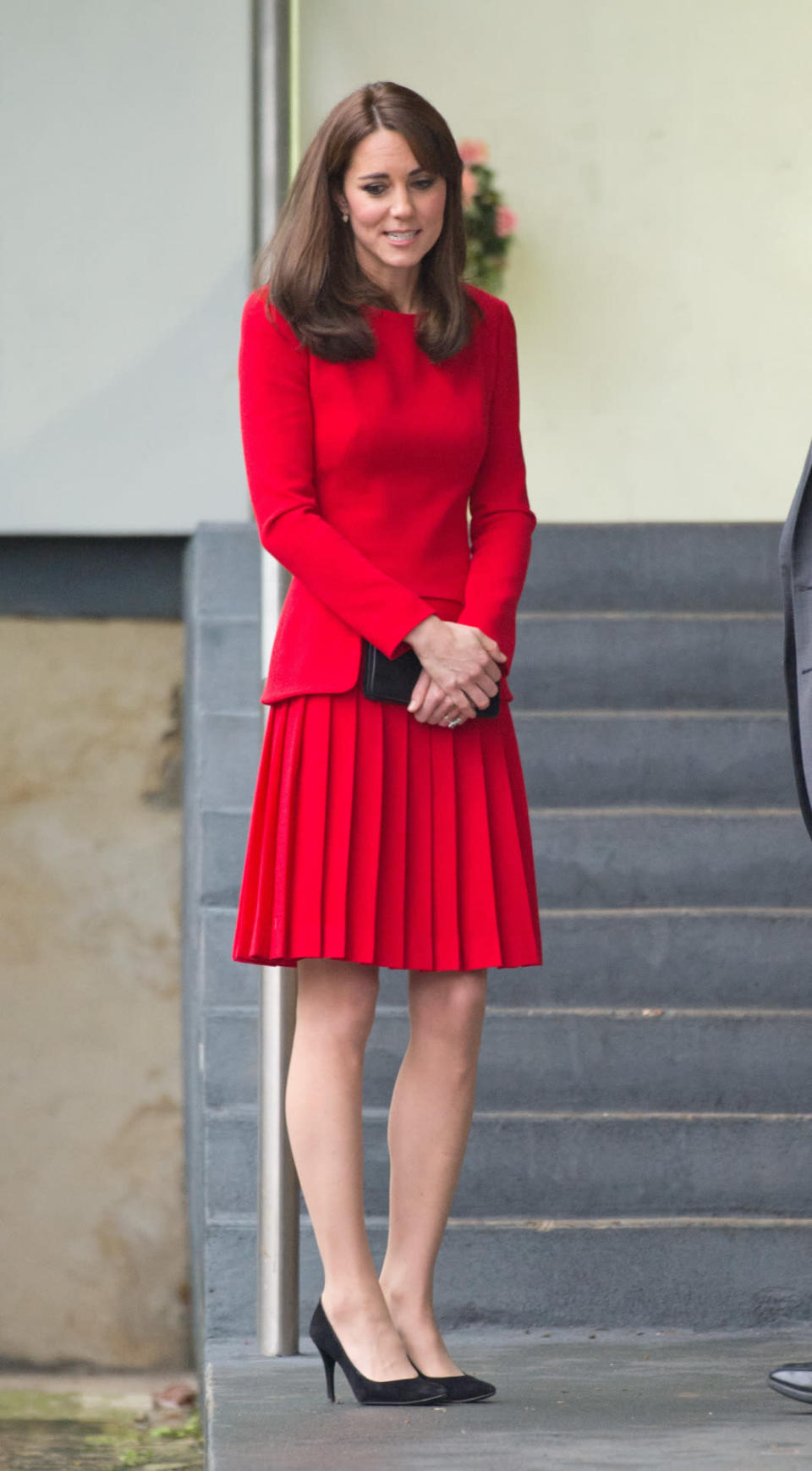 <p>Out for a Christmas lunch, Kate dressed in a vibrant red buttoned Luisa Spagnoli jacket and coordinating skirt with black Stuart Weitzman pumps. </p><p><i>[Photo: PA]</i></p>