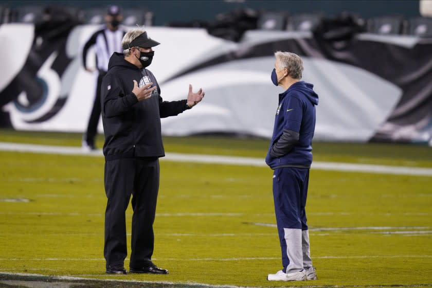 Philadelphia Eagles head coach Doug Pederson, left, and Seattle Seahawks head coach Pete Carroll talk before an NFL football game, Monday, Nov. 30, 2020, in Philadelphia. (AP Photo/Chris Szagola)