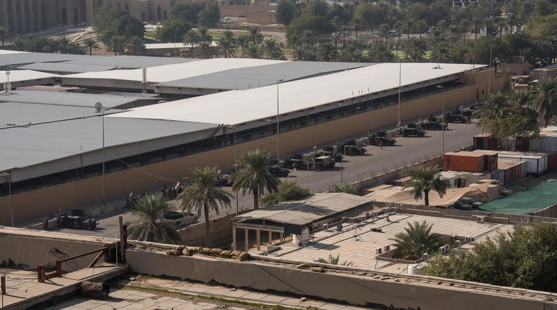 Iraqi Security Forces vehicles line up in the street outside the U.S. embassy compound in Baghdad